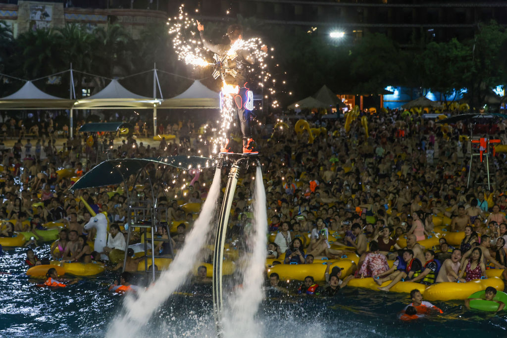 This photo taken on Aug. 15, 2020 shows people watching a performance as they cool off in a swimming pool in Wuhan in China’s central Hubei province.