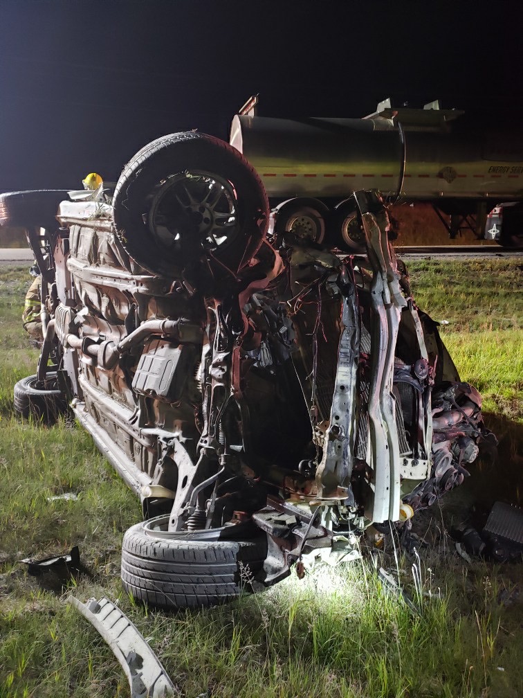 A vehicle drove into oncoming traffic on a highway, clipped a semi-truck and caught fire in a ditch near Cochrane on Sunday, Aug. 2, 2020.