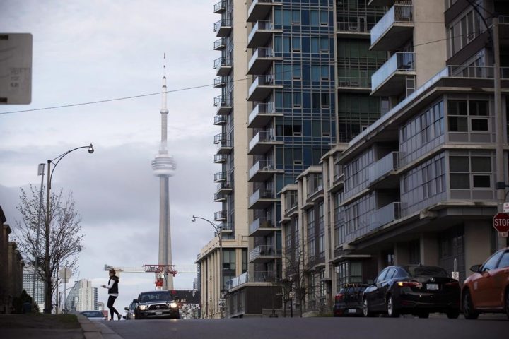 The CN Tower can be seen behind condos in Toronto's Liberty Village community in Toronto, Ontario on Tuesday, April 25, 2017. As rent cheques come due, some are warning that Ontarians should prepare for a wave of evictions now that protections put in place earlier in the COVID-19 pandemic have been lifted.