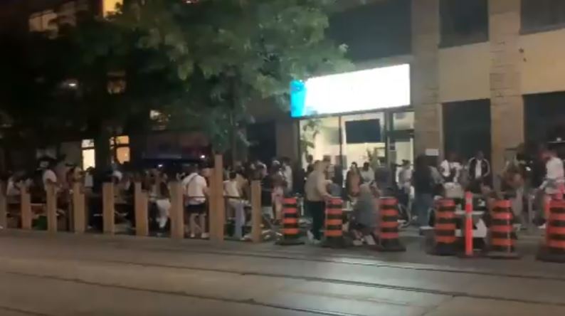 A photo of crowding at a bar in Toronto.