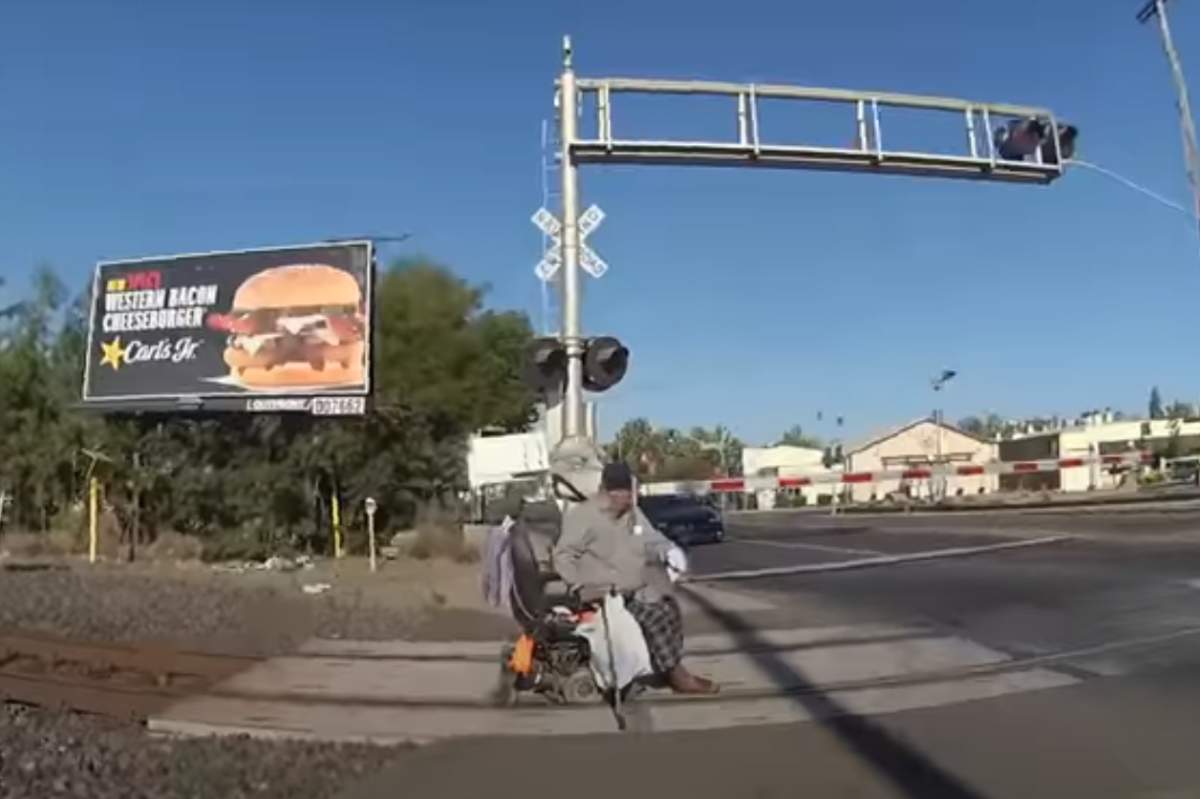 A man is shown sitting on the railway tracks in Lodi, Calif., on Aug. 12, 2020.