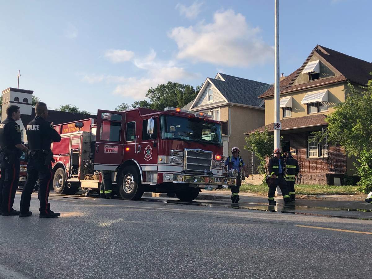Winnipeg Fire Paramedic Service crews survey the scene of a house fire that sent one of their own to hospital.