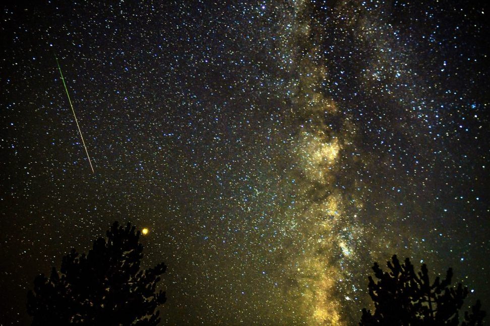 A meteor streaks through the night sky, past planet Mars (C, left), during the Perseid meteor shower over the lake of Kozjak, some 45km from the capitol Skopje, the Former Yugoslav Republic of Macedonia, 13 August 2018.
