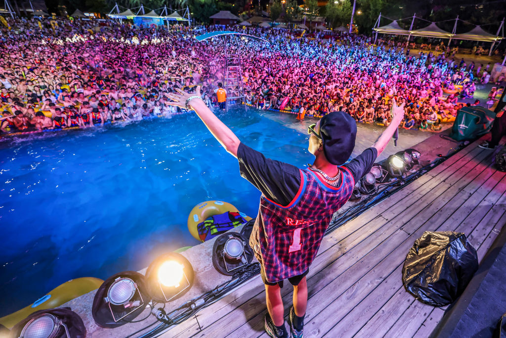This photo taken on Aug. 15, 2020 shows people watching a performance as they cool off in a swimming pool in Wuhan in China’s central Hubei province.