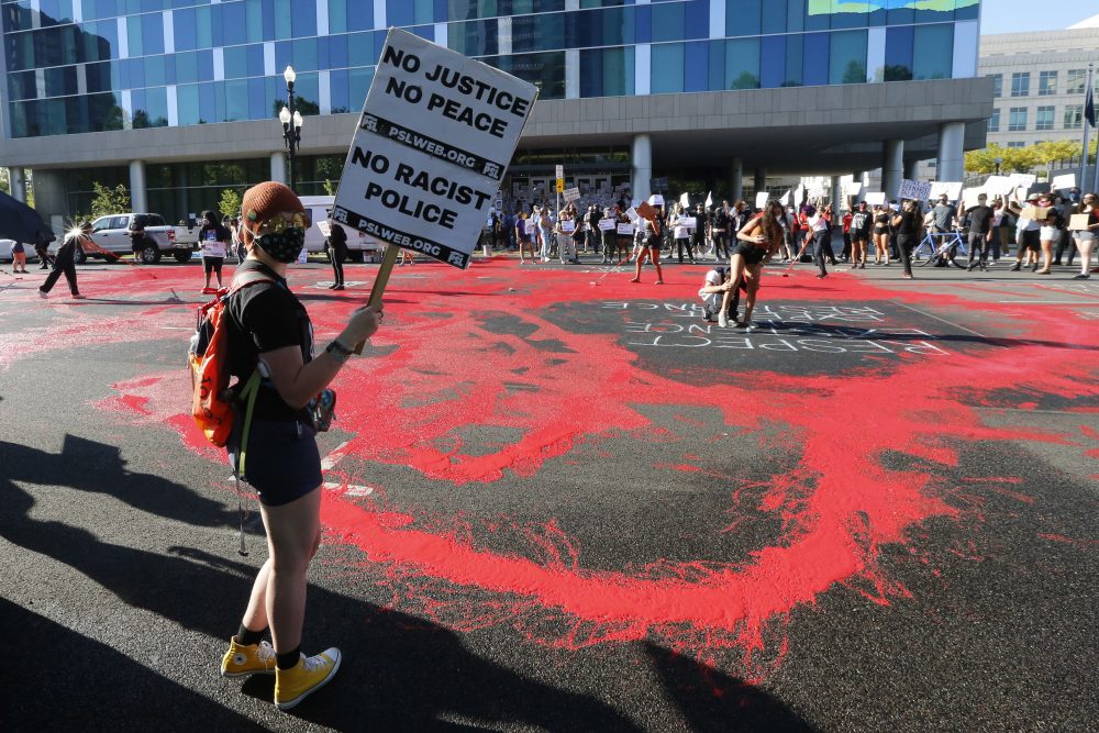 Protesters gather in front of district attorney’s office Thursday, July 9, 2020, in Salt Lake City.