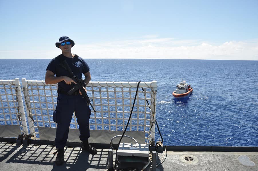 Maritime Enforcement Specialist 1st Class Samuel Cintron is shown keeping watch during a swim call on the U.S. Coast Guard Cutter Kimball.