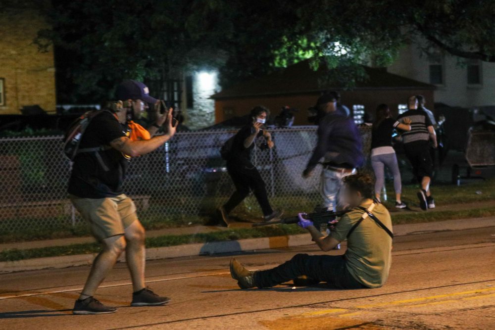 The suspect in a shooting in Kenosha, Wisc., is shown after firing his rifle on Aug. 25, 2020.