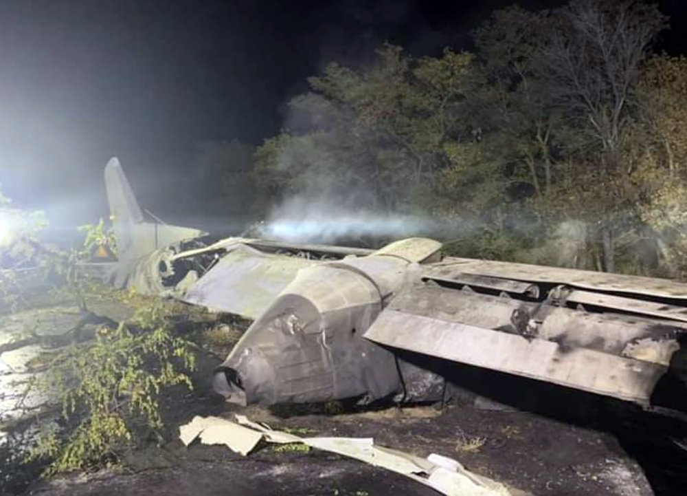 In this photo released by Kharkiv Regional State Administration, wreckage of an AN-26 military plane seen after it crashed in the town of Chuguyiv close to Kharkiv, Ukraine, late Friday, Sept. 25, 2020. A Ukrainian military plane carrying students at an aviation school crashed and burst into flames while landing, killing more than twenty people. Two other people on board were seriously injured and four people were missing. 