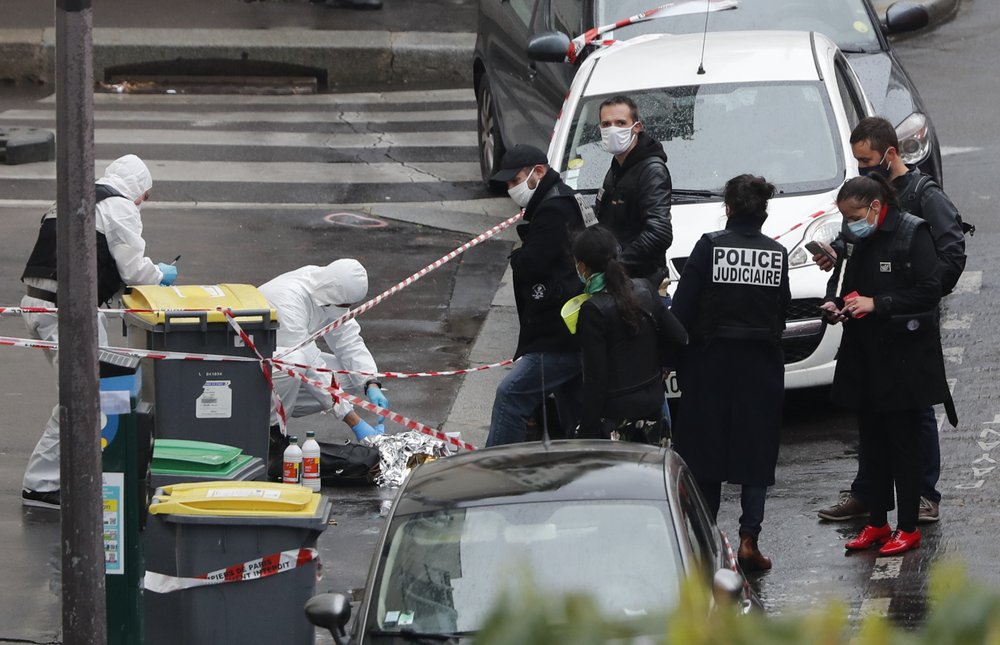 Police officers gather in the area of a knife attack near the former offices of satirical newspaper Charlie Hebdo, Friday Sept. 25, 2020 in Paris. Paris police say they have arrested a man suspected of a knife attack that wounded at least two people near the former offices of satirical newspaper Charlie Hebdo. Police initially thought there were two attackers but now say there was only one. 