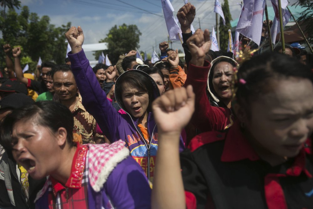 Palm oil workers hold a rally demanding to be treated fairly in Rantau Prapat, North Sumatra, Indonesia, on Nov. 15, 2017.