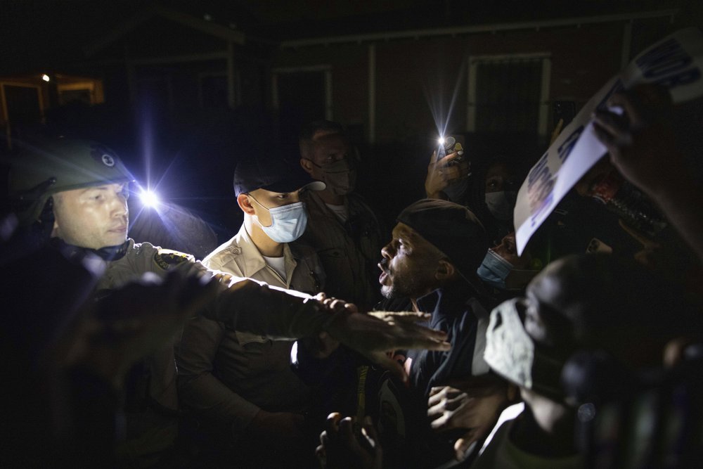 Protesters clash with deputies of the Los Angeles Sheriff's Department during protests following the death of Dijon Kizzee on Monday, Aug. 31, 2020, in Los Angeles, Calif. 