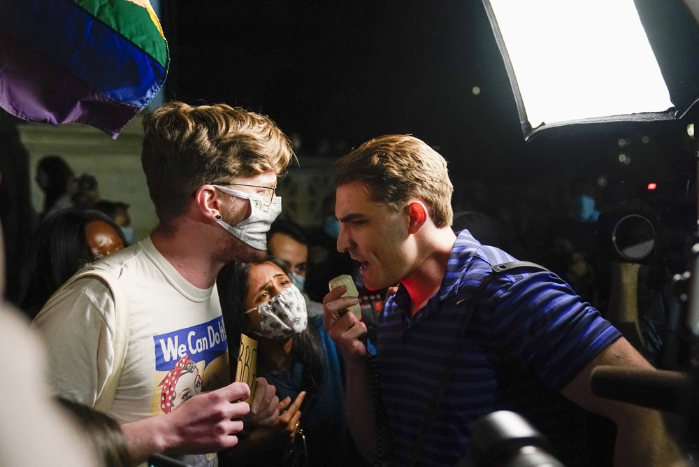 A demonstrator at right argues with people gathered at the Supreme Court to mourn the death of Justice Ruth Bader Ginsburg, Friday, Sept. 18, 2020, in Washington.