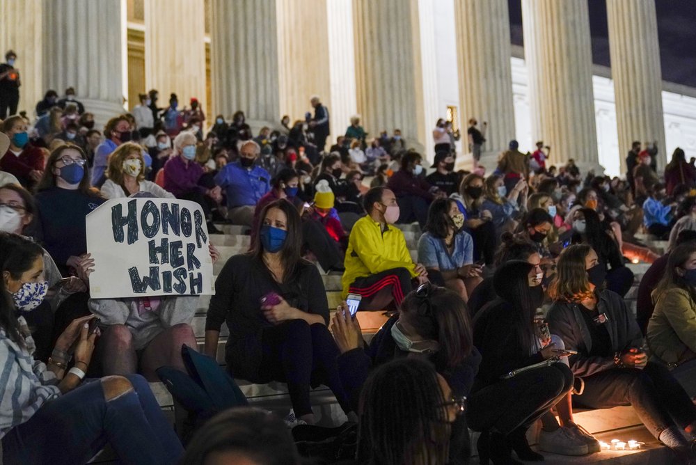 People gather at the Supreme Court Friday, Sept. 18, 2020, in Washington, after the Supreme Court announced that Supreme Court Justice Ruth Bader Ginsburg has died of metastatic pancreatic cancer at age 87.