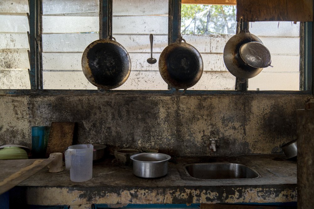 Pots and pans hang in the kitchen of workers’ living quarters in a palm oil plantation run by the government-owned Felda in Malaysia in early 2020.