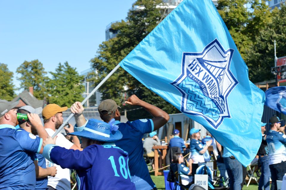 Denton Froese carries a HFX Wanderers FC flag at a fan event to watch the team compete in Prince Edward Island in 2020.