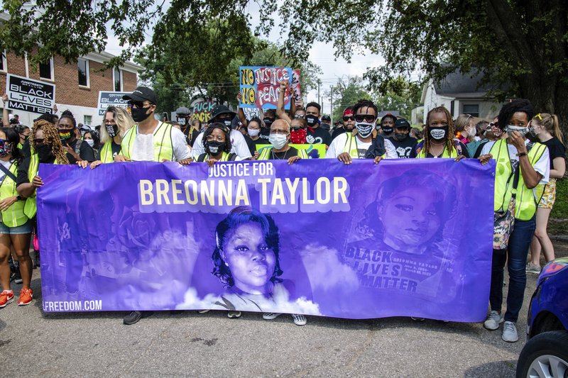 FILE - Protesters participate in the Good Trouble Tuesday march for Breonna Taylor, on Tuesday, Aug. 25, 2020, in Louisville, Ky. A lawyer for Breonna Taylor's family said a plea deal was offered to an accused drug trafficker that would have forced him to implicate Taylor, who was killed by police in a raid on her home in March. Louisville's top prosecutor acknowledged the existence of the document but said it was part of preliminary plea negotiations with a man charged with illegal drug trafficking and not an attempt to smear Taylor.