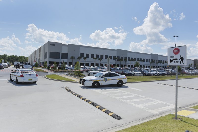FILE - In this Monday, June 29, 2020, file photo, law enforcement respond to a report of a shooting at the Amazon Fulfillment Center on Pecan Park Road near the Jacksonville International Airport in Jacksonville, Fla. The Jacksonville Sheriff’s Department said on its Twitter account late Tuesday, Sept. 29, 2020, that there was a report of a shooting at the Amazon Fulfillment Center. The center was also the site of a shooting in June. 