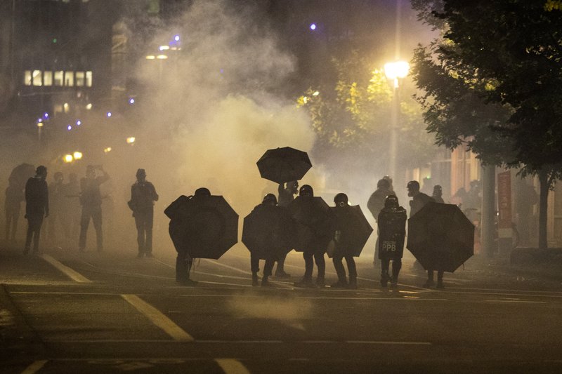 Tear gas fills the air during protests, Friday, Sept. 18, 2020, in Portland, Ore. The protests, which began over the killing of George Floyd, often result frequent clashes between protesters and law enforcement.
