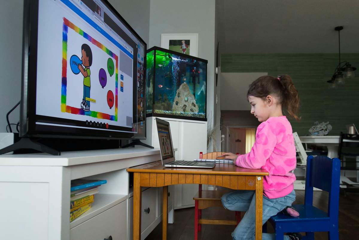 Six-year-old Peyton Denette works remotely from her home in Mississauga, Ont., on Monday, March 30, 2020. 