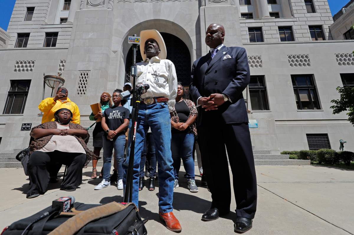Tommie McGlothen, Sr., father of Tommie McGlothen, Jr., speaks to media outside the Caddo Parish Courthouse with attorney James Carter, right, and family members in Shreveport, La., Wednesday, June 10, 2020. 