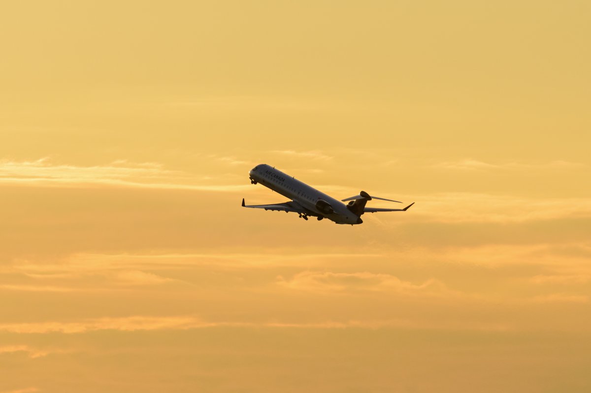 In a file photo, an Air Canada Express Bombardier CRJ900 jet airborne after take-off at sunset from Vancouver International Airport, Richmond, B.C. on Saturday, July 4, 2020.