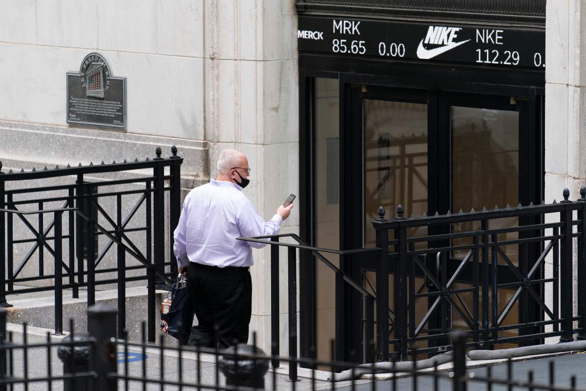 A man enters the New York Stock Exchange, Monday, Aug. 31, 2020, in New York.