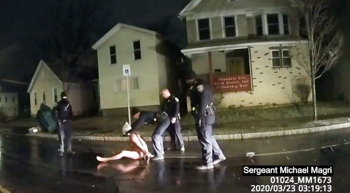 In this image taken from police body camera video provided by Roth and Roth LLP, a Rochester police officer puts a hood over the head of Daniel Prude, on March 23, 2020, in Rochester, N.Y.