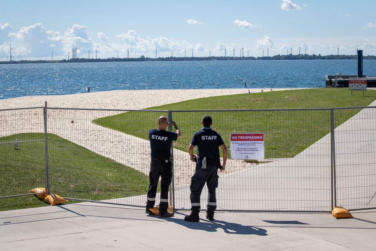 City of Kingston staff close the Gord Downie pier at Lake Ontario after people failed to social distance while at the park, in Kingston, Ont., on Saturday. Sept. 5, 2020. The park is now closed due to COVID-19 and there will be a $500 fine for anyone that enters.