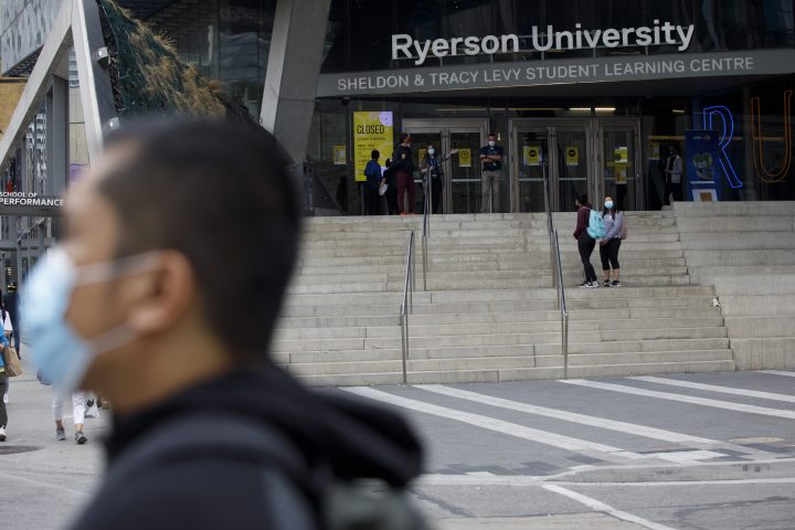 People are seen on the front steps of Ryerson University on campus in Toronto, Tuesday, Sept. 8, 2020.