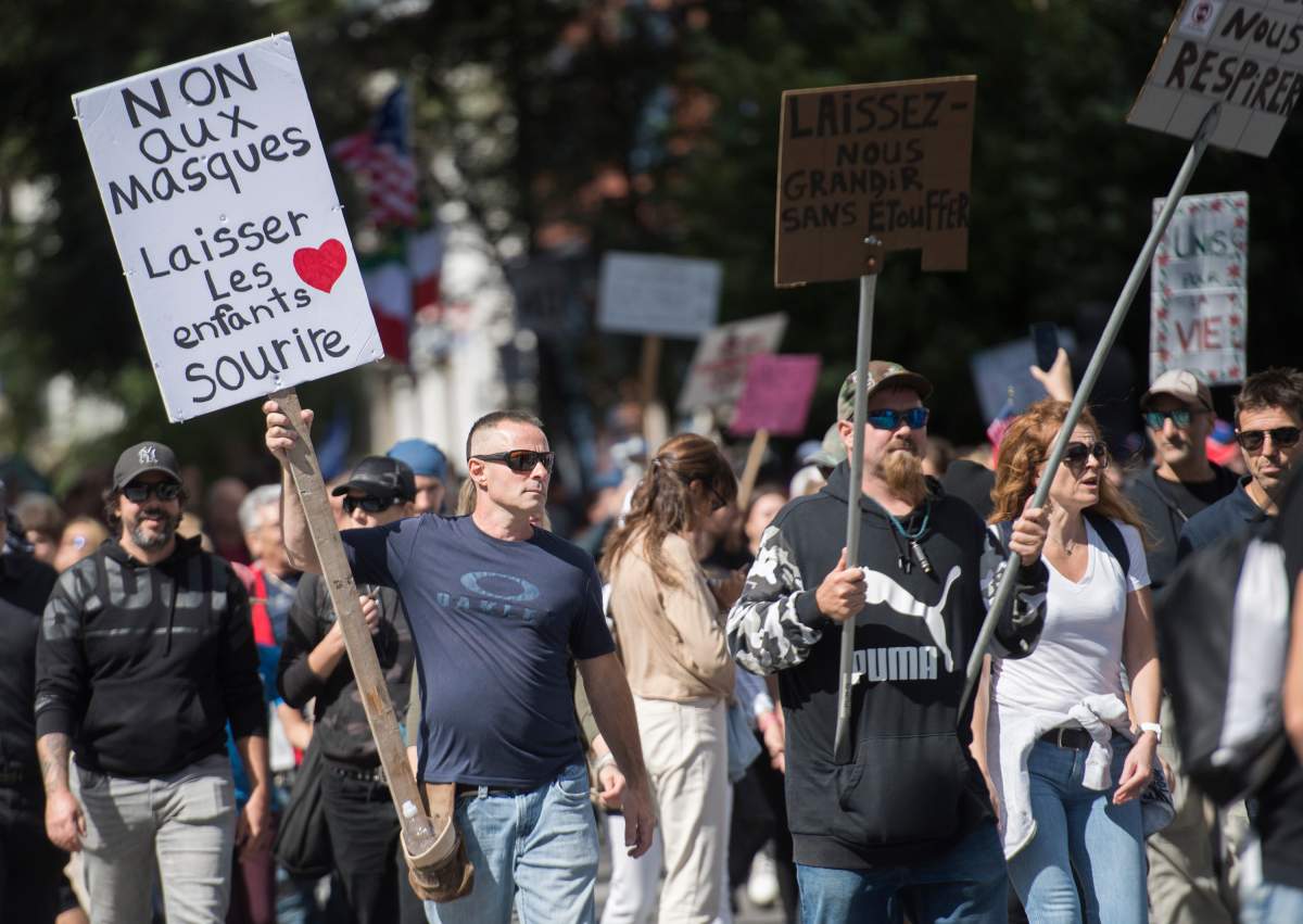 People take part in a demonstration opposing the mandatory wearing of face masks in Montreal, Saturday, September 12, 2020, as the COVID-19 pandemic continues in Canada and around the world.