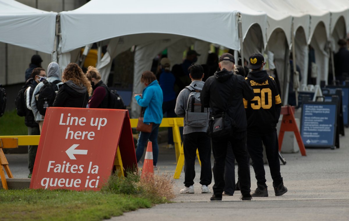 People line up outside the Brewer Arena testing facility in Ottawa, Tuesday, Sept. 15, 2020. 