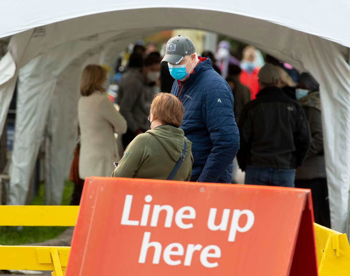 People line up outside a COVID-19 testing facility in Ottawa, Tuesday, Sept. 15, 2020.  