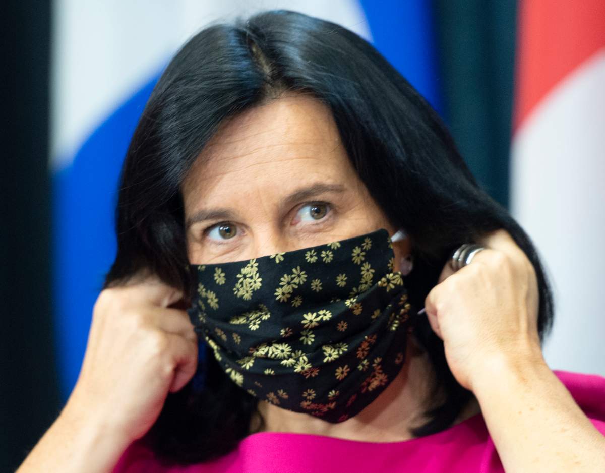 Montreal Mayor Valérie Plante removes her face mask as she arrives at a news conference, Friday, Sept. 18, 2020  in Montreal.