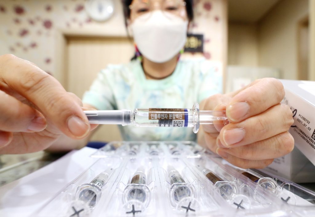 A nurse shows a flu vaccine at a clinic in Seoul, South Koream 22 September 2020. The Korea Disease Control and Prevention Agency said on 22 September, South Korea will temporarily halt its plan to offer free seasonal flu vaccines due to storage issues involving inactivated bottles.  