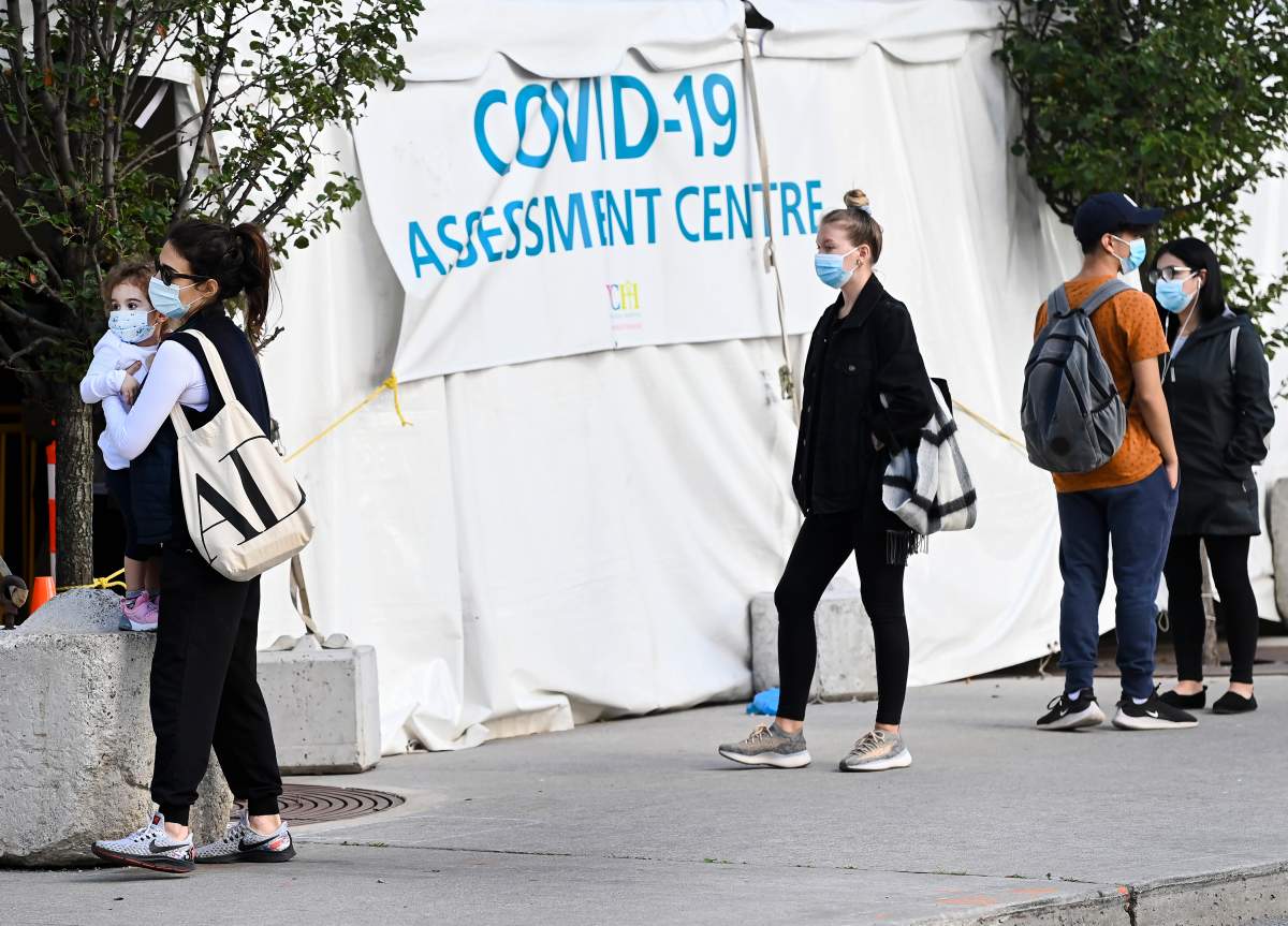 People wait in line at a COVID assessment centre at Women's College Hospital during the COVID-19 pandemic in Toronto on Wednesday, September 23, 2020. THE CANADIAN PRESS/Nathan Denette.