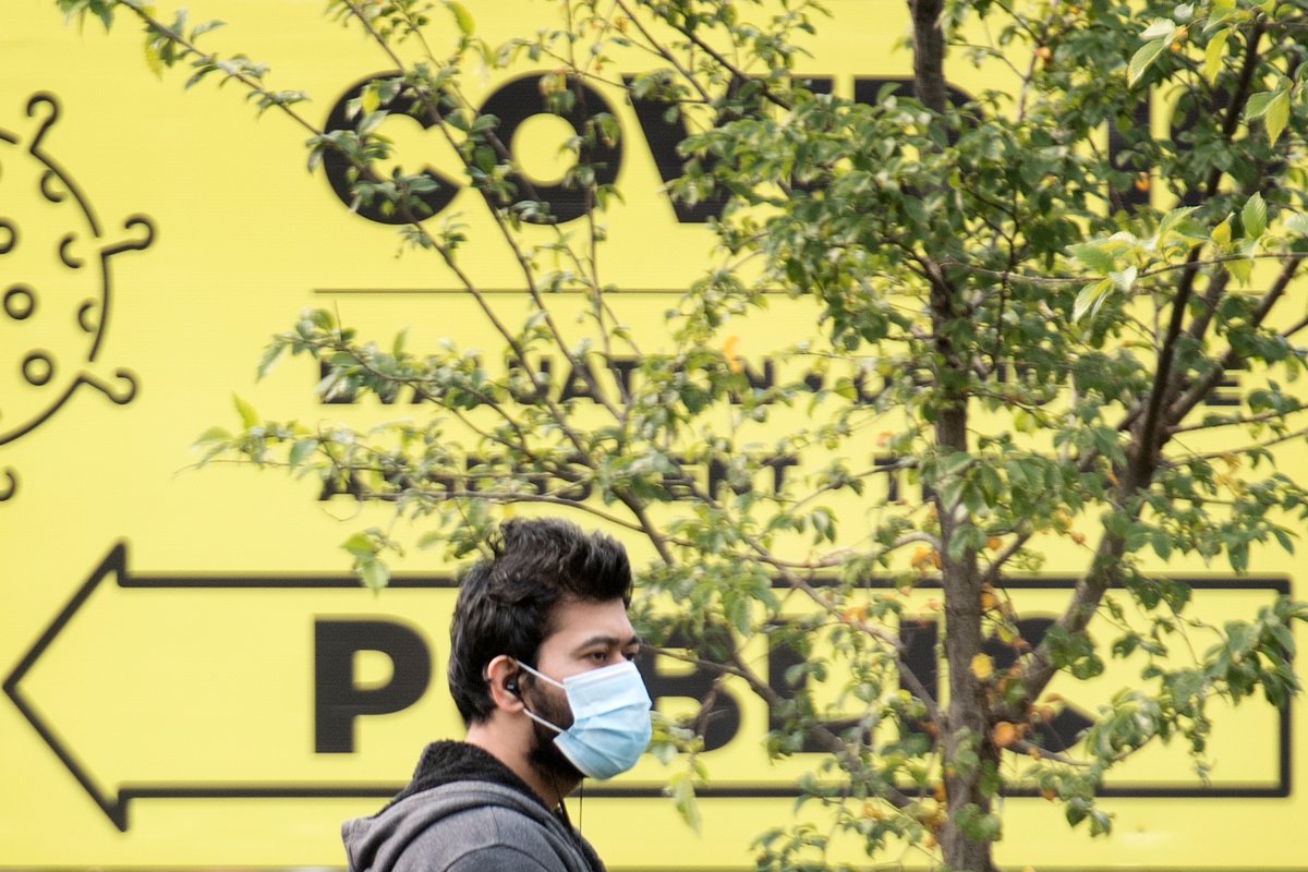 A man wears a face mask as he waits outside a COVID-19 testing clinic in Montreal, Sunday, Sept. 27, 2020, as the COVID-19 pandemic continues in Canada and around the world. 