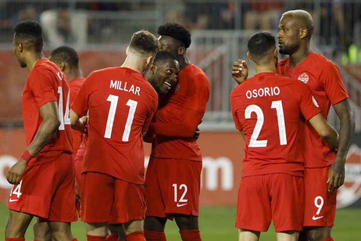 Canada defender Doneil Henry, centre left, celebrates with teammates midfielder Liam Millar (11) and midfielder Alphonso Davies (12) as he celebrates a goal during second half of CONCACAF Nations League play in Toronto on September 7, 2019. 