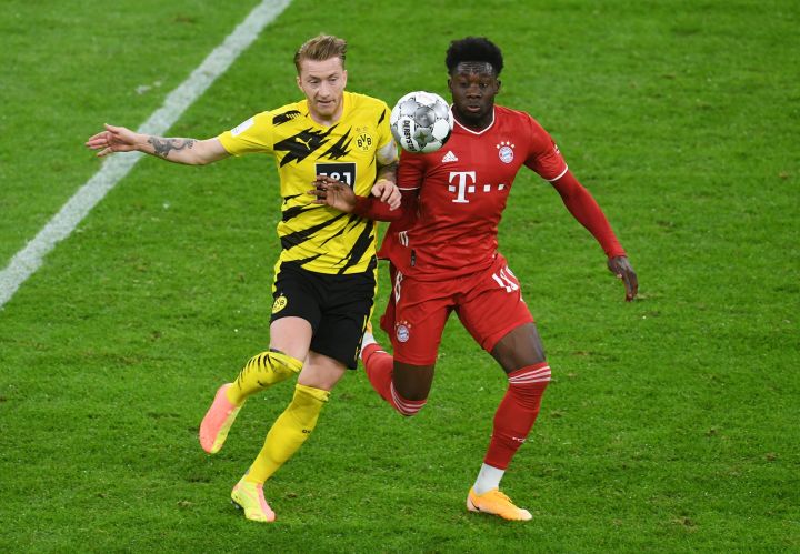 Bayern Munich's Alphonso Davies (R) in action against Borussia Dortmund's Marco Reus (L) during the German DFL Supercup soccer match between Bayern Munich and Borussia Dortmund in Munich, Germany, 30 September 2020.  