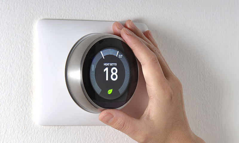 A smart thermostat being installed as part of SaskPower's new energy assistance program.