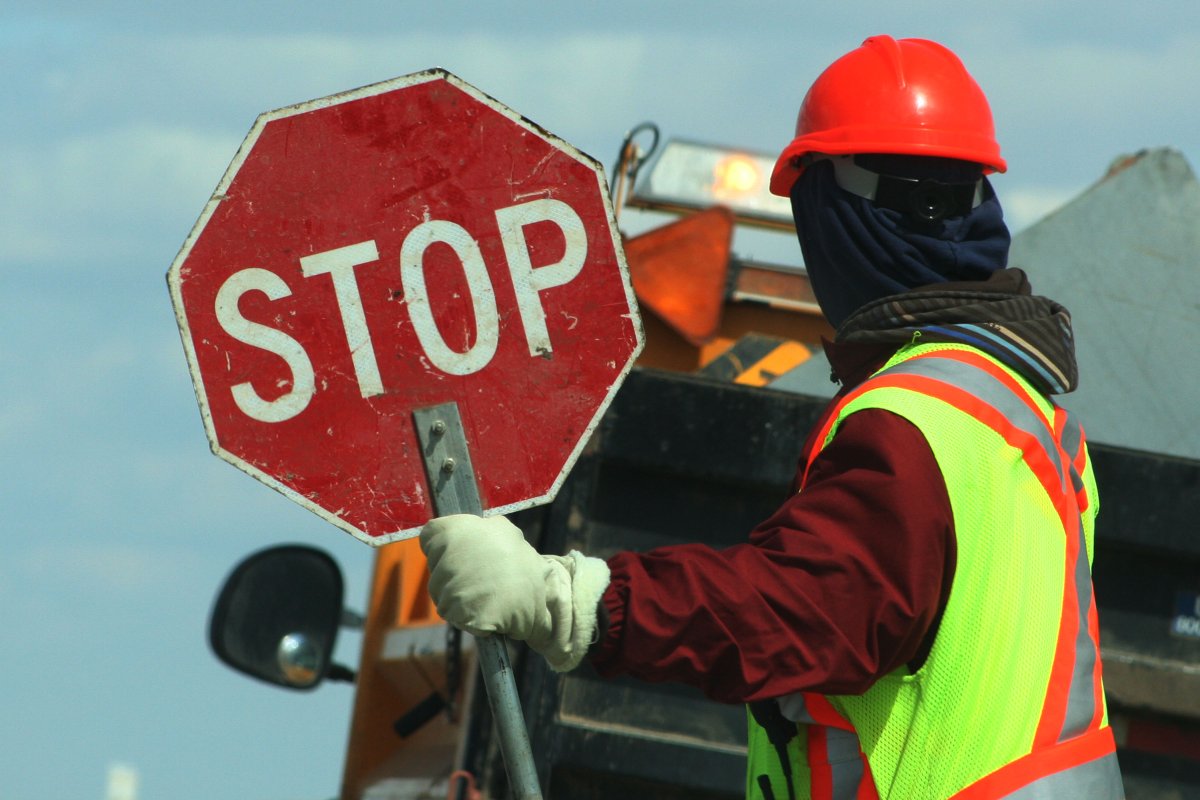 Road crews with a stop sign