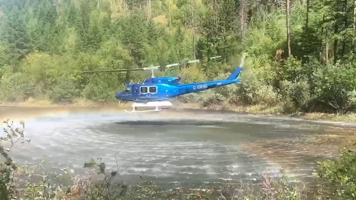 Located around 20 kilometres west of Penticton, the Green Mountain Road fire is listed at 1.5 hectares. Here, a helicopter fills up from a pond near the blaze.