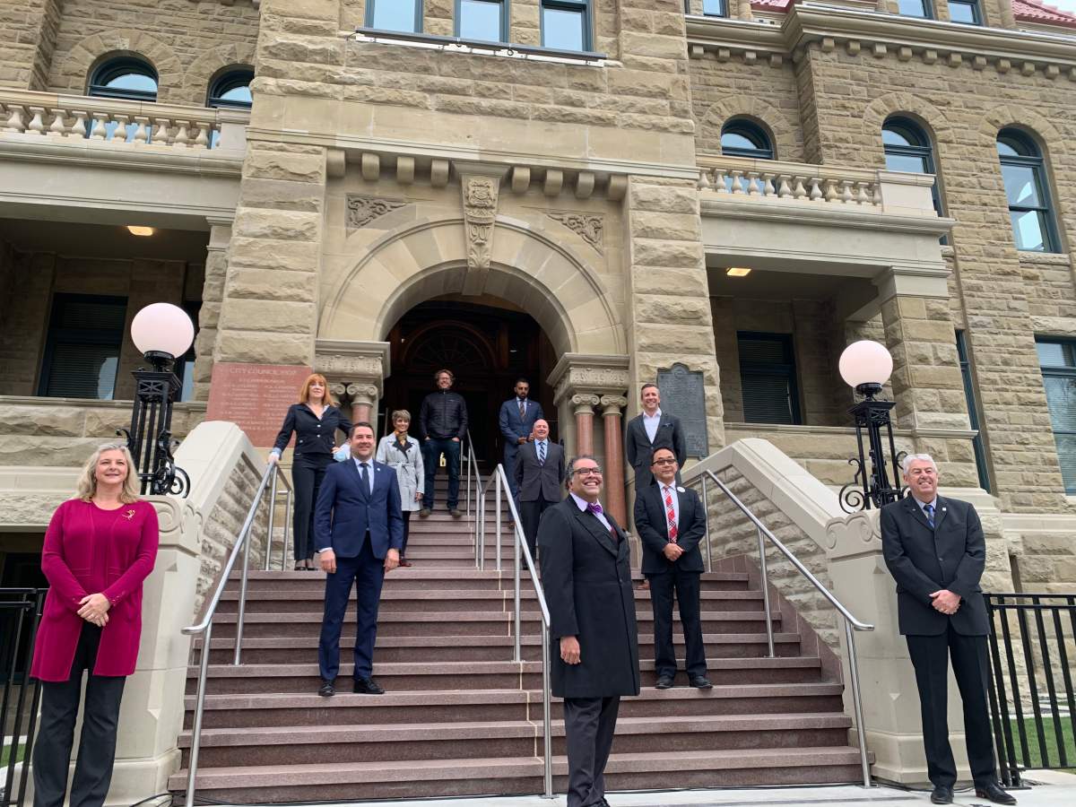 Members of Calgary’s city council stand on the steps of Historic City Hall on Sept. 15, 2020, following a 3-year, $34-million rehabilitation project.