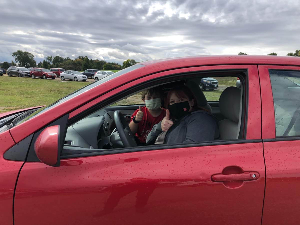 Zorra Township mother Jessica Pilatzkie waits in line with her son at the mobile testing site in Dorchester.