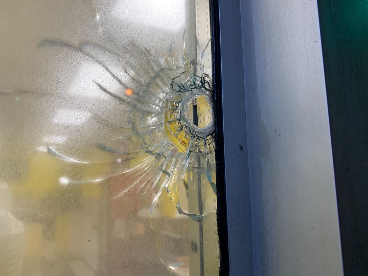 A bullet hole is seen in one of the window’s of the bakery