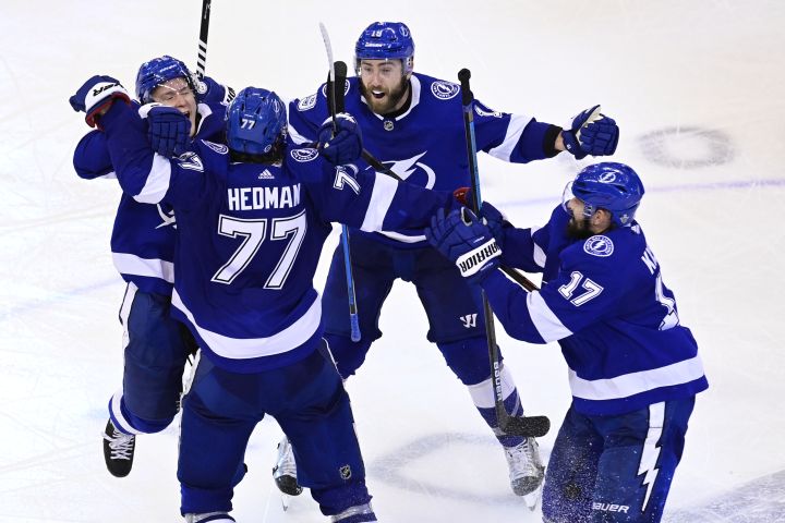 Tampa Bay Lightning defenceman Victor Hedman (77) celebrates his game-winning goal against the Boston Bruins with teammate Ondrej Palat (18), Patrick Maroon (14) and Alex Killorn (17) during the second overtime period of NHL Stanley Cup Eastern Conference playoff hockey action in Toronto on Monday, Aug. 31, 2020. 