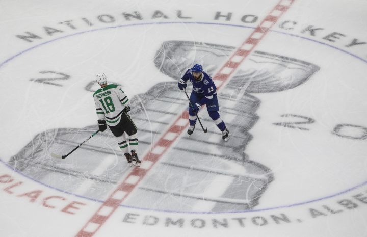 Dallas Stars' Jason Dickinson (18) and Tampa Bay Lightning's Cedric Paquette (13) warm up before the NHL Stanley Cup finals in Edmonton on Monday, September 21, 2020. 