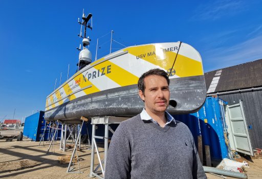 Neil Tinmouth, Sea-Kit International’s chief operating officer, standing beside the USV Maxlimer at the company’s headquarters in Tollesbury, England.