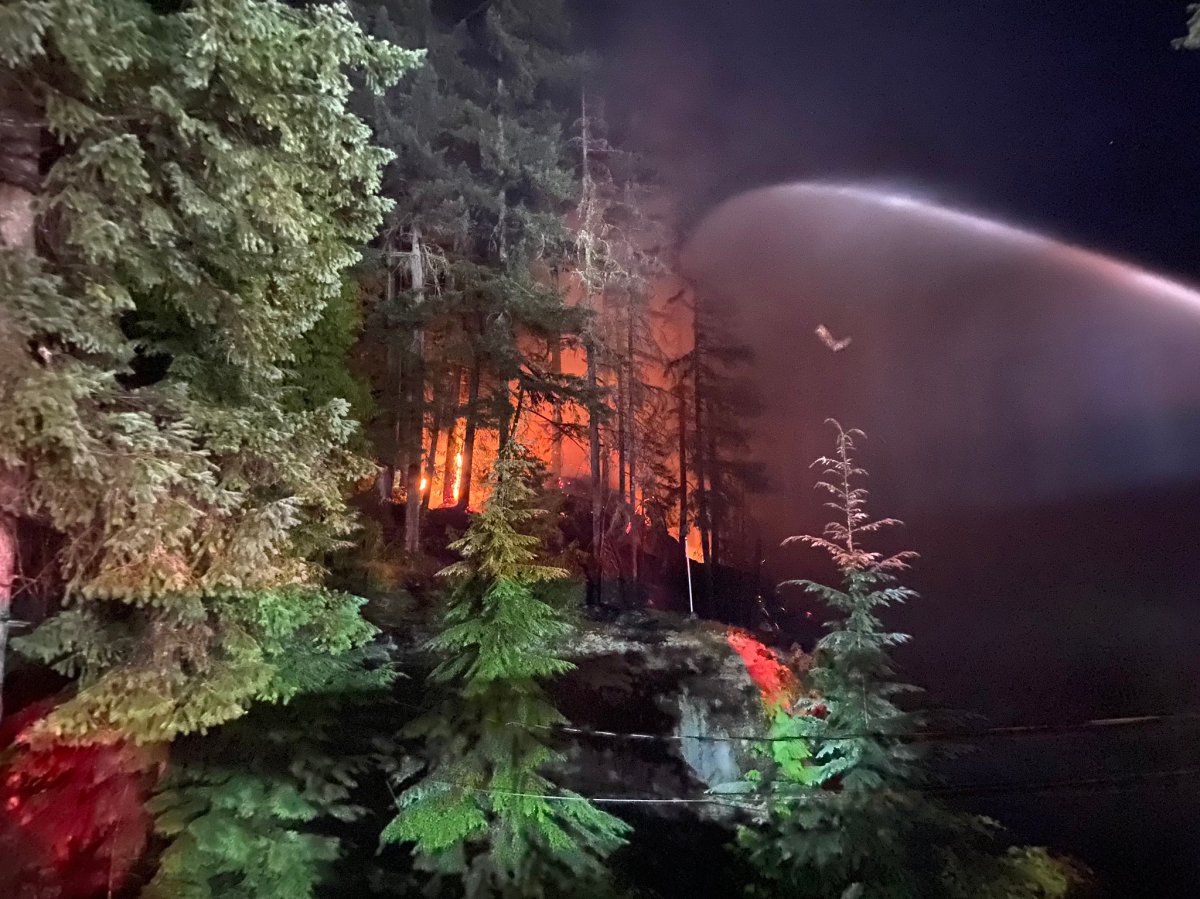 North Vancouver Fire Rescue Services crews, battling a blaze in a forested area of North Vancouver in the 5000 block of Sunshine Falls in the Woodlands area of Deep Cove near the waterfront.