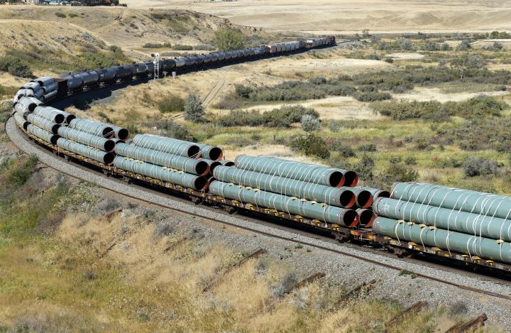 Sections of oil pipeline are transported on a westbound Canadian Pacific Railway (CPR) freight train near Medicine Hat, Alberta, Canada on Sept. 11, 2020. 