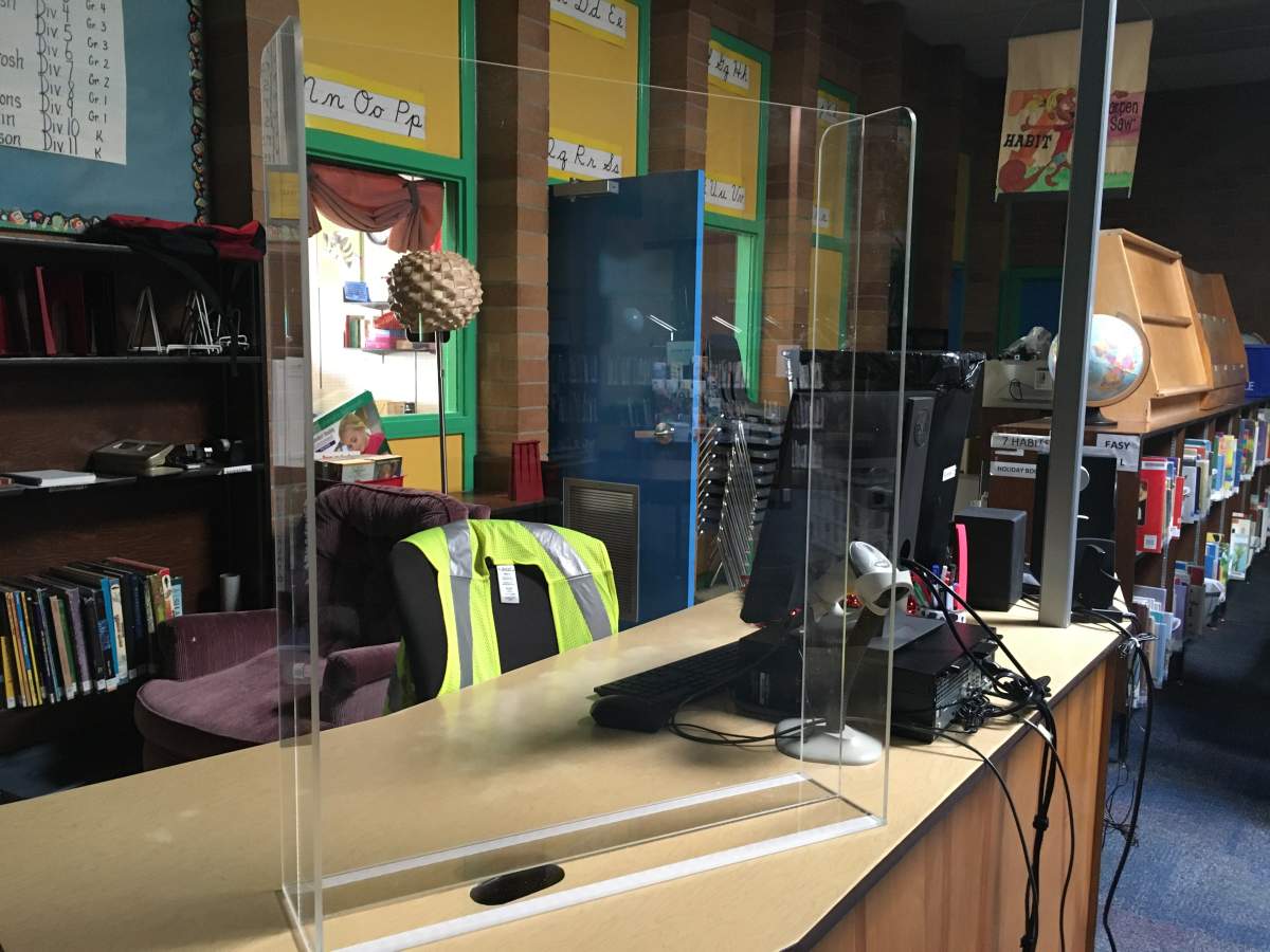A plexi-glass barrier is installed in the library at Queen’s Park Elementary School.